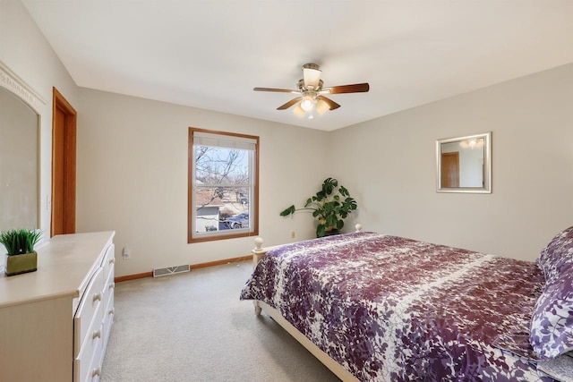 bedroom with light carpet, visible vents, a ceiling fan, and baseboards