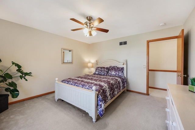 bedroom with visible vents, light colored carpet, and baseboards