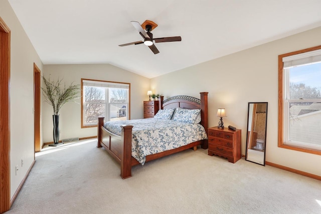 bedroom featuring baseboards, light carpet, a ceiling fan, and vaulted ceiling