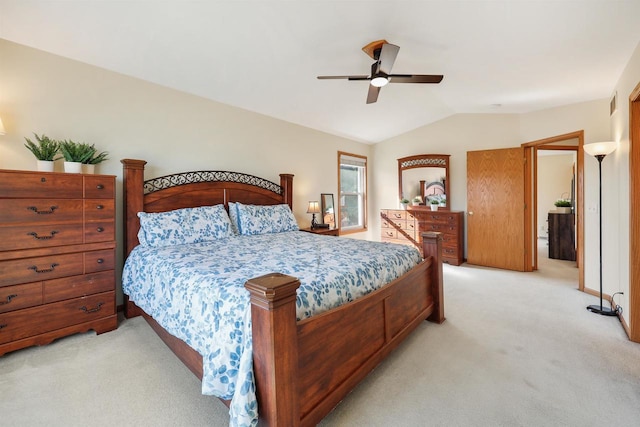 bedroom with visible vents, light colored carpet, ceiling fan, and vaulted ceiling