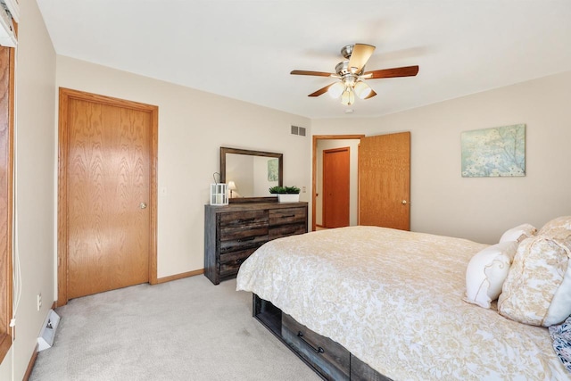 bedroom featuring ceiling fan, visible vents, baseboards, and light carpet