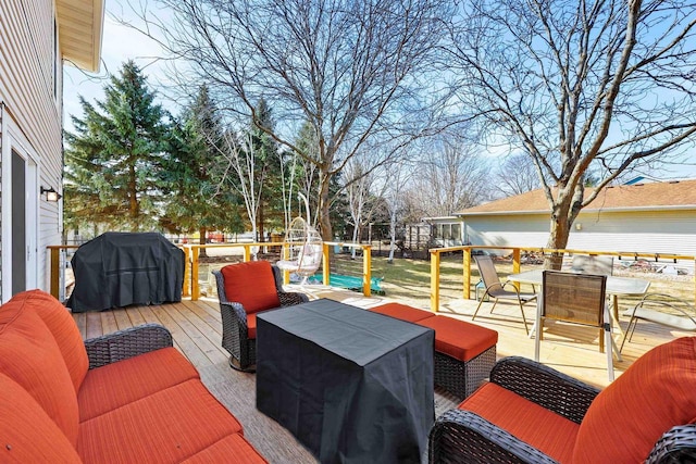 wooden terrace with outdoor dining space, area for grilling, and an outdoor hangout area