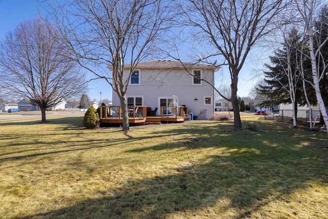 back of property featuring a yard and a deck