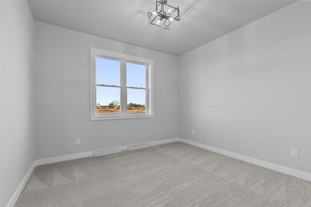 spare room featuring baseboards, visible vents, and light colored carpet