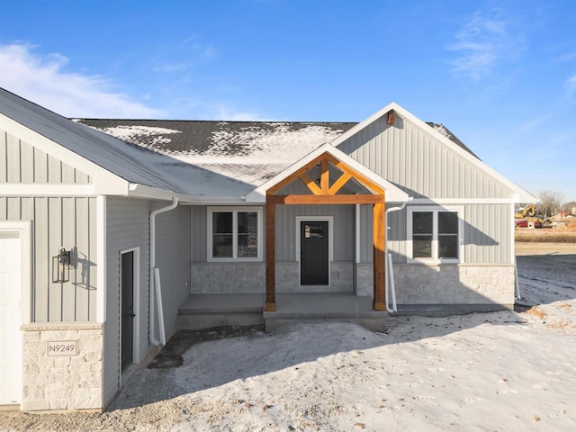 view of front of house with board and batten siding and stone siding