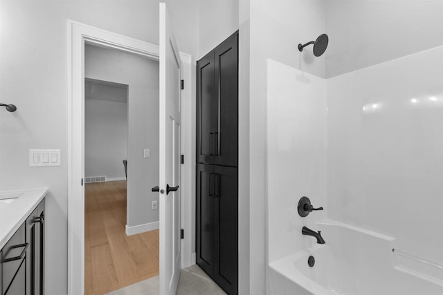 full bathroom featuring baseboards, visible vents, wood finished floors, bathtub / shower combination, and vanity