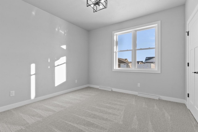 spare room featuring light carpet, visible vents, and a wealth of natural light