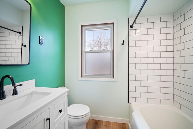 full bathroom with shower / tub combination, toilet, wood finished floors, vanity, and baseboards