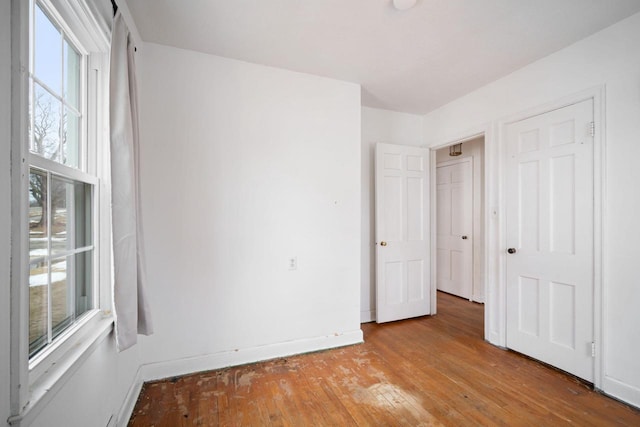 unfurnished bedroom with light wood-type flooring and baseboards