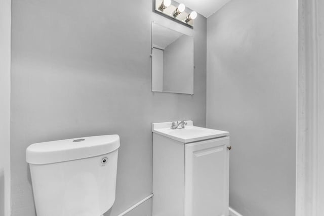 bathroom featuring toilet and vanity