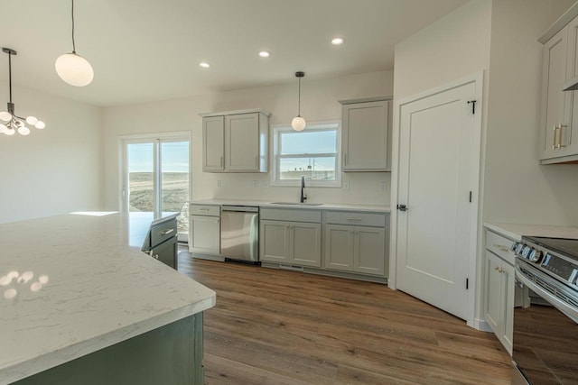 kitchen featuring dark wood-style floors, appliances with stainless steel finishes, a sink, and a healthy amount of sunlight