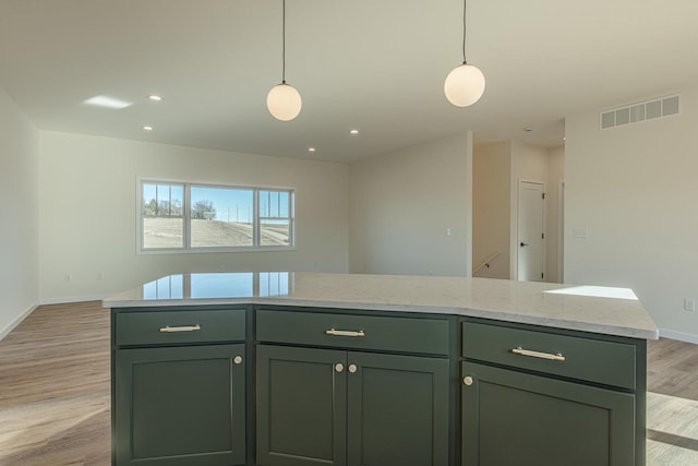 kitchen featuring light wood-type flooring, visible vents, pendant lighting, and green cabinetry