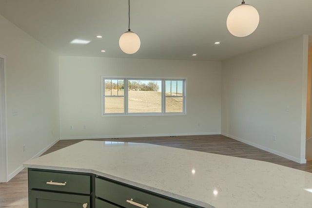 kitchen featuring hanging light fixtures, light wood-style floors, and recessed lighting