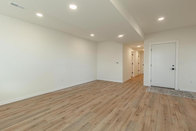 spare room with light wood-type flooring, visible vents, baseboards, and recessed lighting