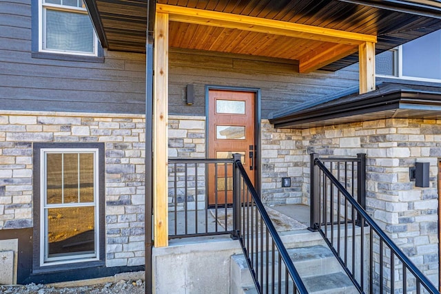 view of exterior entry featuring stone siding