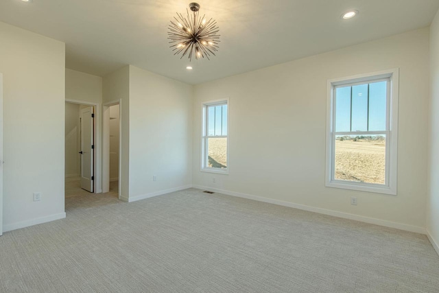 interior space with light colored carpet, baseboards, a chandelier, and recessed lighting