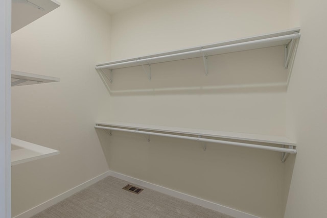 walk in closet featuring carpet and visible vents