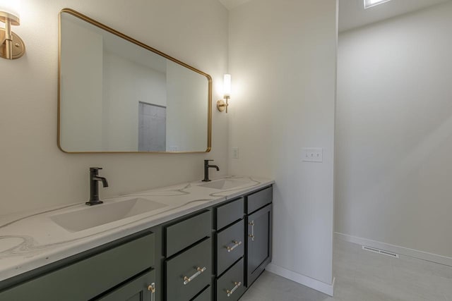 full bathroom with double vanity, visible vents, baseboards, and a sink