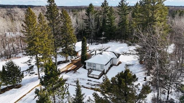 snowy aerial view with a forest view