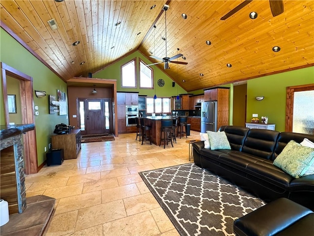 living room with high vaulted ceiling, wooden ceiling, a ceiling fan, and stone tile floors