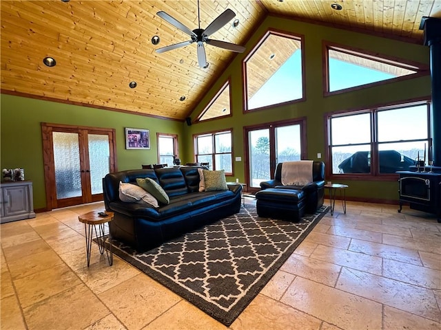 living area with a wood stove, wooden ceiling, stone tile floors, and french doors