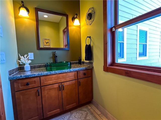 bathroom featuring baseboards and vanity