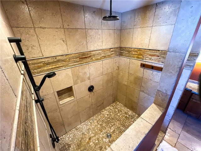 bathroom with a tile shower