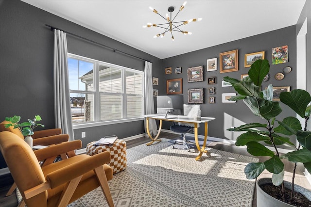 office space featuring baseboards, a chandelier, and wood finished floors