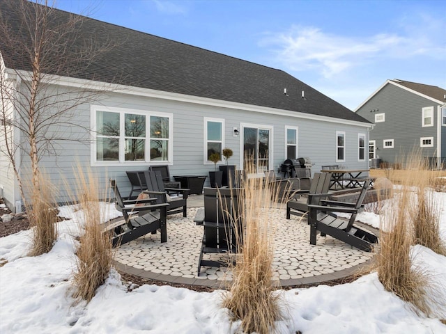 view of snow covered back of property