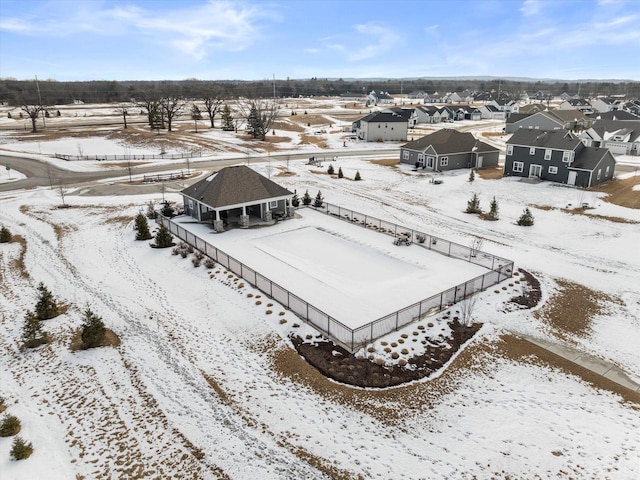 snowy aerial view featuring a residential view