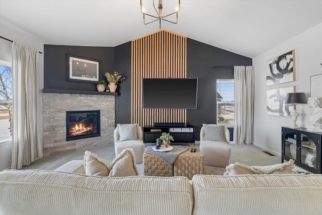 carpeted living room with a fireplace, lofted ceiling, a chandelier, and baseboards