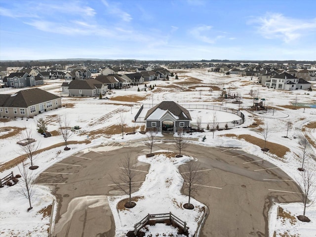 snowy aerial view with a residential view