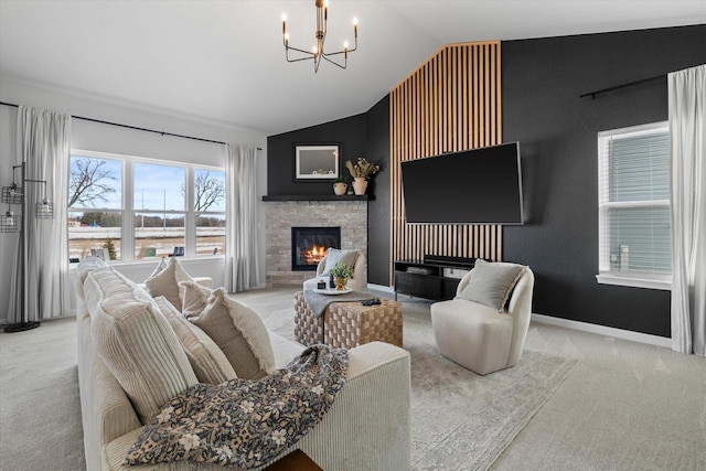 living room with lofted ceiling, a stone fireplace, carpet flooring, a chandelier, and baseboards