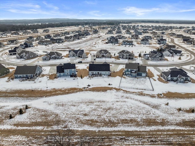 snowy aerial view with a residential view