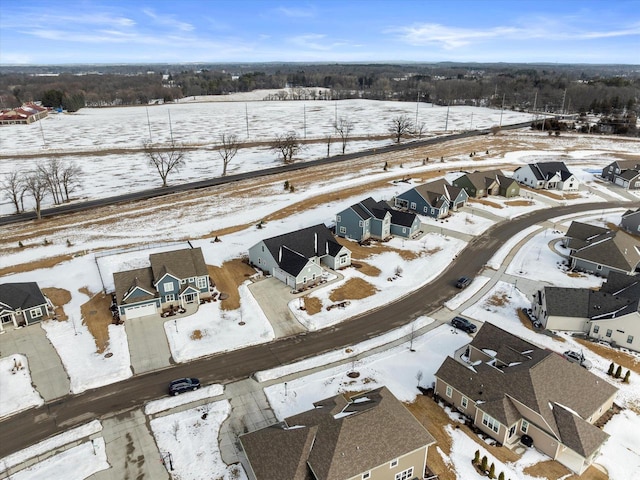 snowy aerial view with a residential view