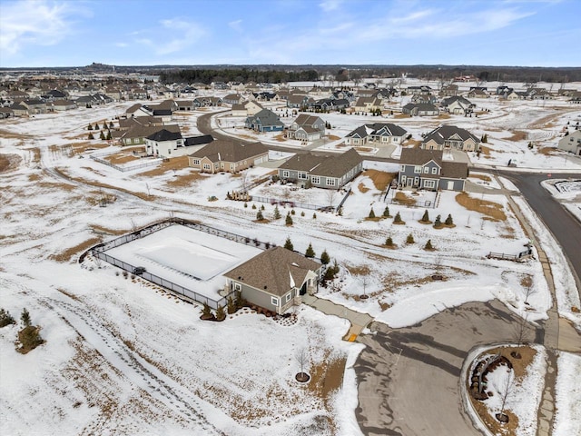 snowy aerial view with a residential view