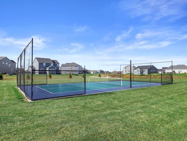 view of sport court featuring a tennis court and a residential view
