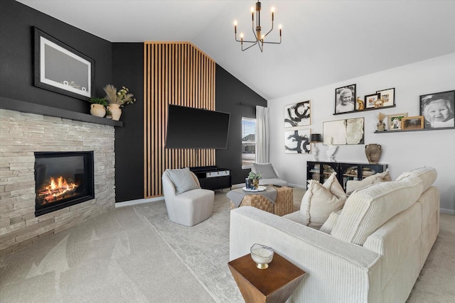 carpeted living room featuring a chandelier, lofted ceiling, a stone fireplace, and baseboards