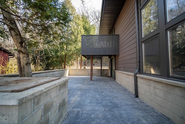 view of home's exterior with a patio and a balcony