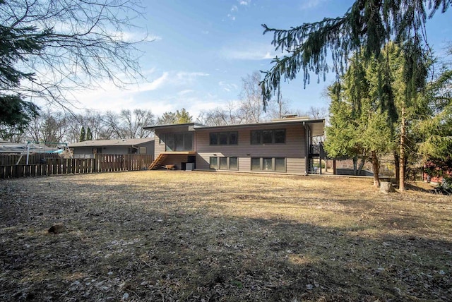 rear view of property featuring fence