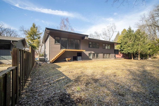 back of house with central air condition unit, stairs, and fence
