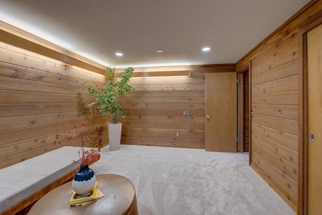 living area with wood walls, carpet, and recessed lighting