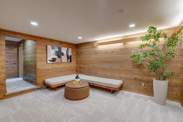 living area with wood walls, carpet floors, and recessed lighting