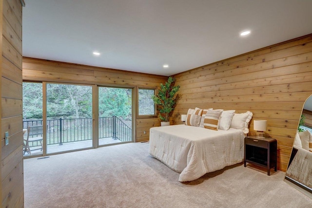 carpeted bedroom featuring recessed lighting, wooden walls, and access to outside