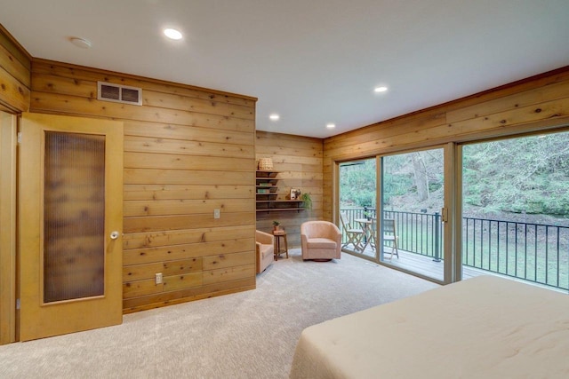 bedroom featuring wood walls, carpet flooring, access to exterior, visible vents, and recessed lighting