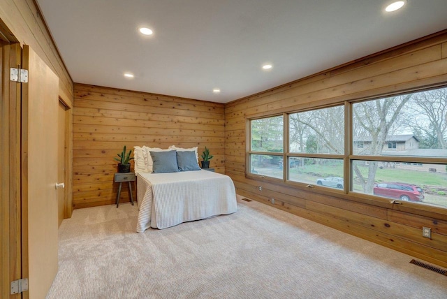 bedroom featuring recessed lighting, carpet, visible vents, and wood walls