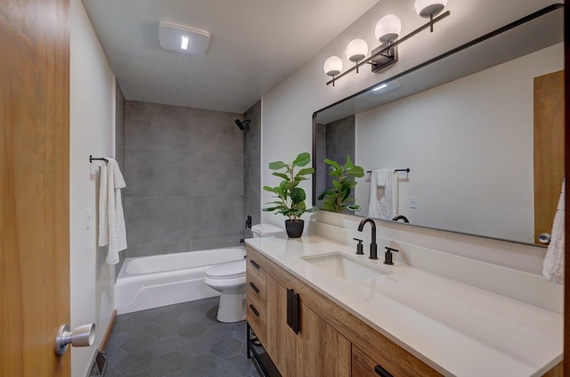 bathroom featuring tile patterned flooring, toilet, vanity, and shower / tub combination