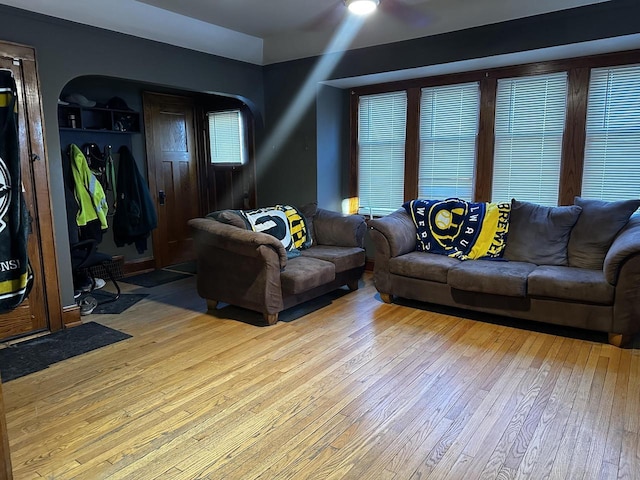 living area featuring light wood finished floors and arched walkways