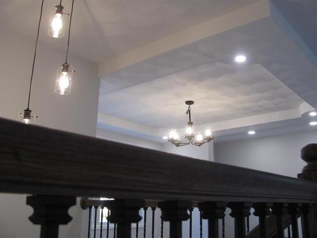 interior details featuring recessed lighting and a raised ceiling