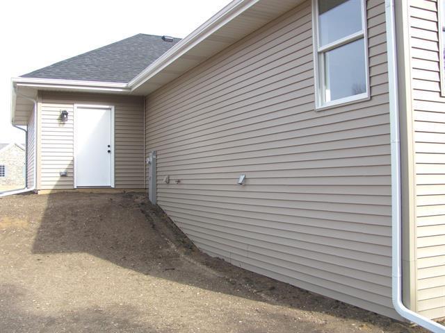 doorway to property featuring roof with shingles